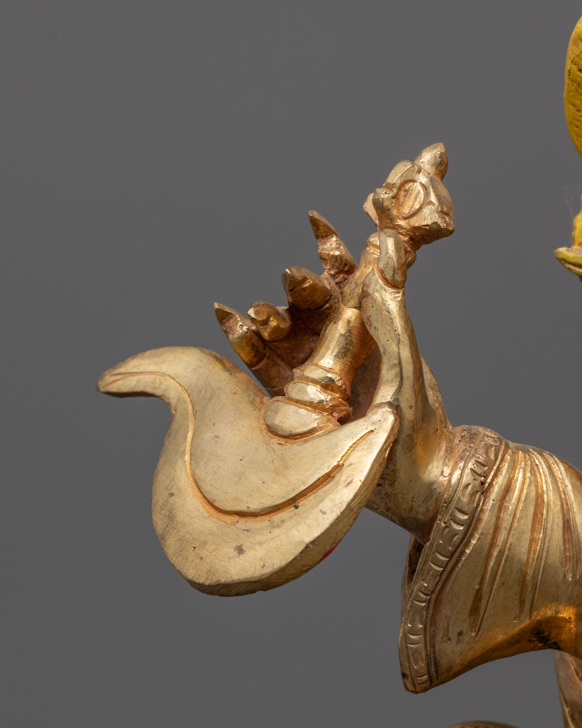 Mahakala Bernagchen holding a curved knife in powerful stance representing the cutting 