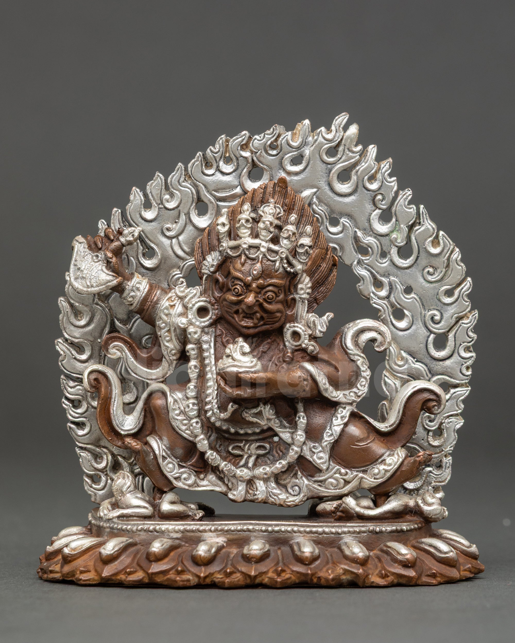 Mahakala Bernagchen holding kartika knife and kapala, wrathful Tibetan Buddhist deity crushing obstacles on lotus seat