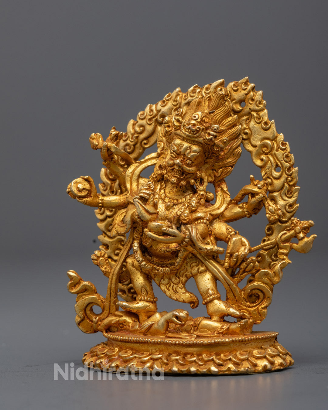 Mahakala holding curved vajra knife and skull cup filled with blood symbolizing destruction of ego