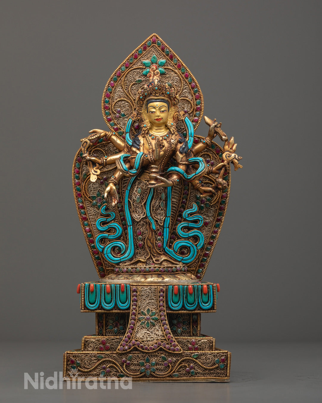 Majestic Standing Chenrezig Statue – 24k gold-gilded Avalokiteshvara figure adorned with semi-precious stones like turquoise, coral, and lapis lazuli, handcrafted using the Lost Wax Method.