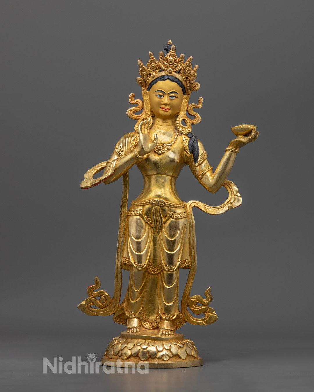 Mandarva statue holding a vase of immortality, intricately carved and gilded, representing enlightened feminine energy in Vajrayana Buddhism.