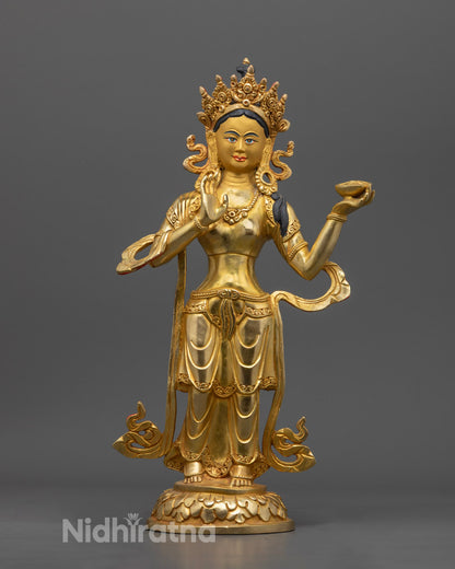 Mandarva statue holding a vase of immortality, intricately carved and gilded, representing enlightened feminine energy in Vajrayana Buddhism.
