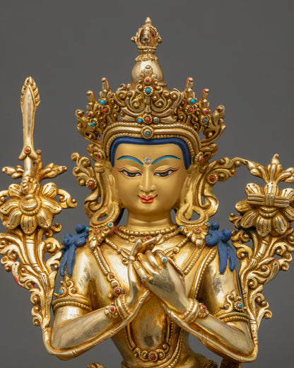 Close-up of Manjushree Sculpture serene expression with full crown and detailed gold-gilded face