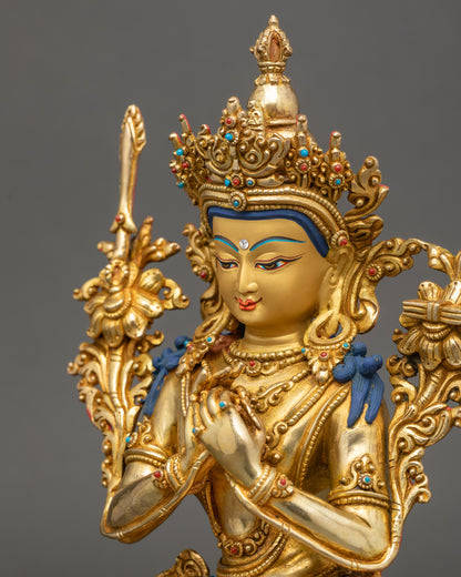 Close-up of Manjushree Sculpture holding utpala stem with blooming flower beside shoulder