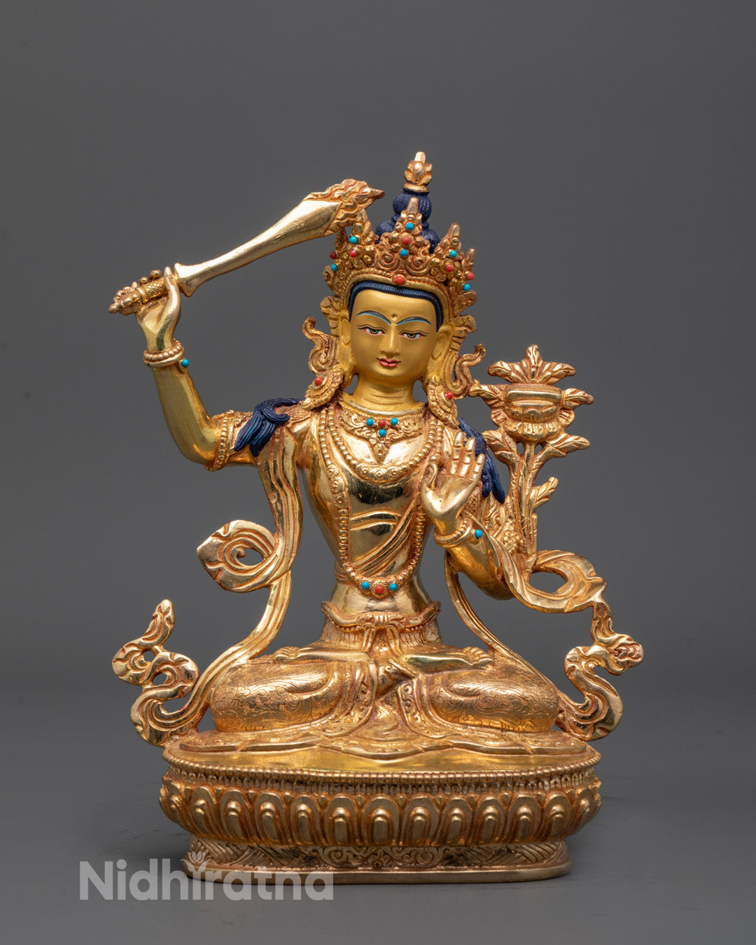 Manjushri Bodhisattva sculpture with gold-gilded face, front view showcasing semi-precious stones
