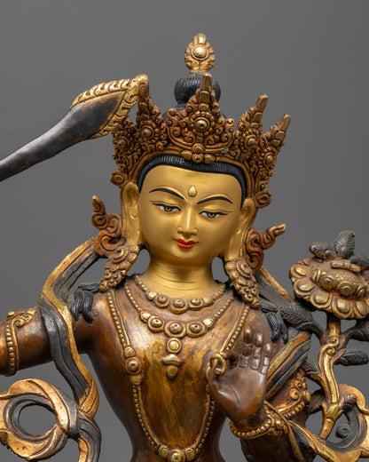 Manjushri Bodhisattva statue holding a double-edged sword with a wisdom flame and vajra handle, symbolizing the cutting of ignorance and duality