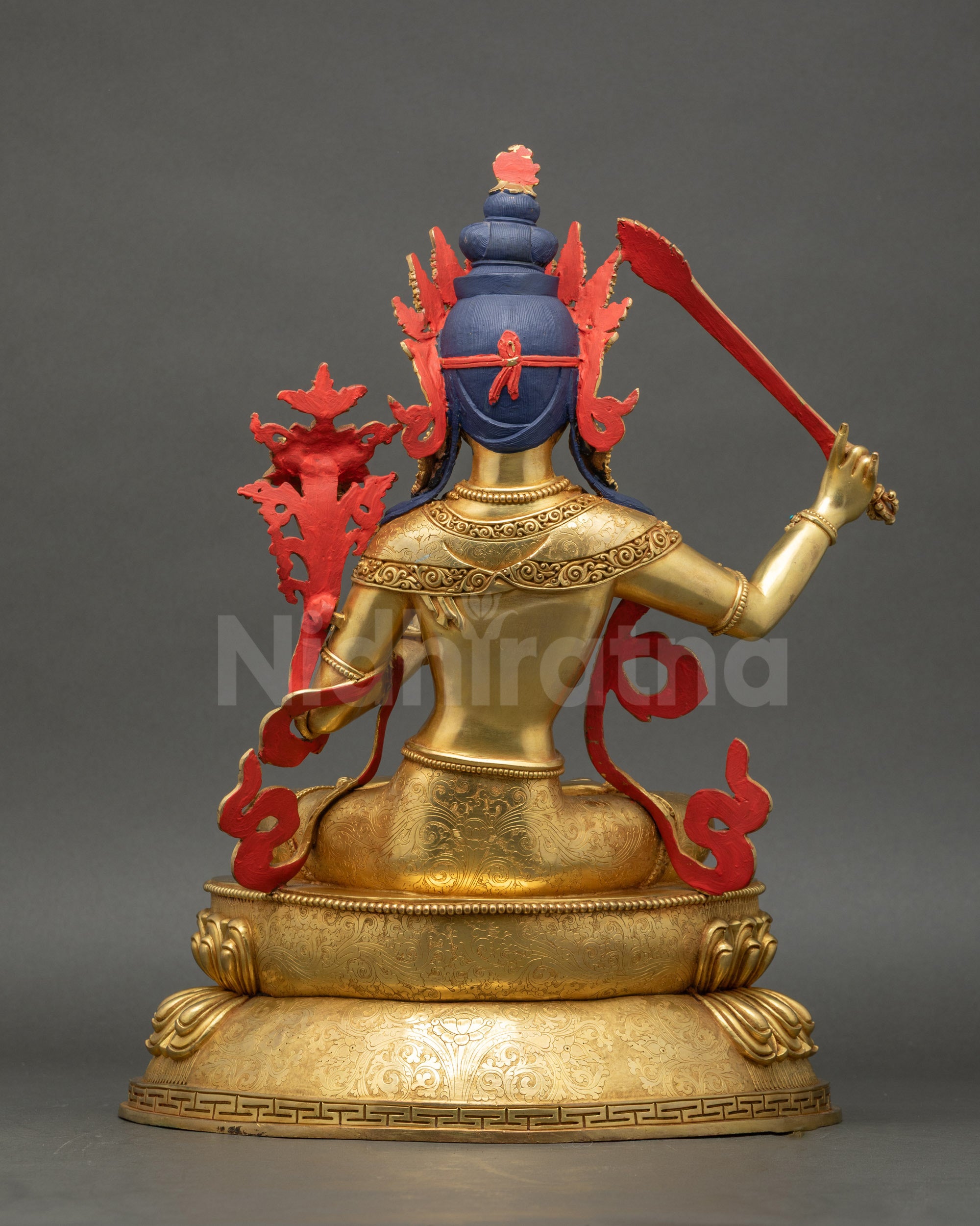 Manjushri Buddha Statue back view displaying carved robes and sacred lotus base