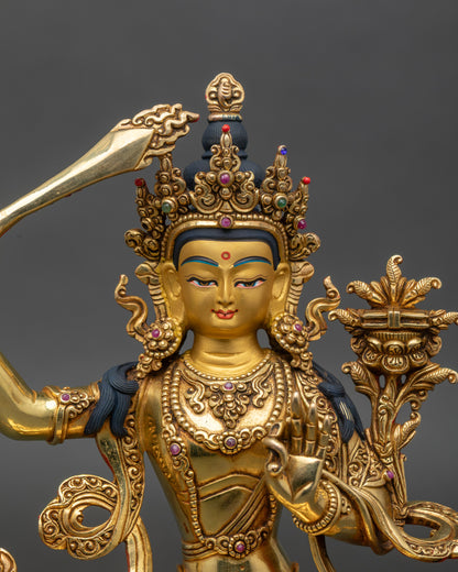Manjushri Buddha close-up, serene expression, gold fire-gilded spiritual figurine