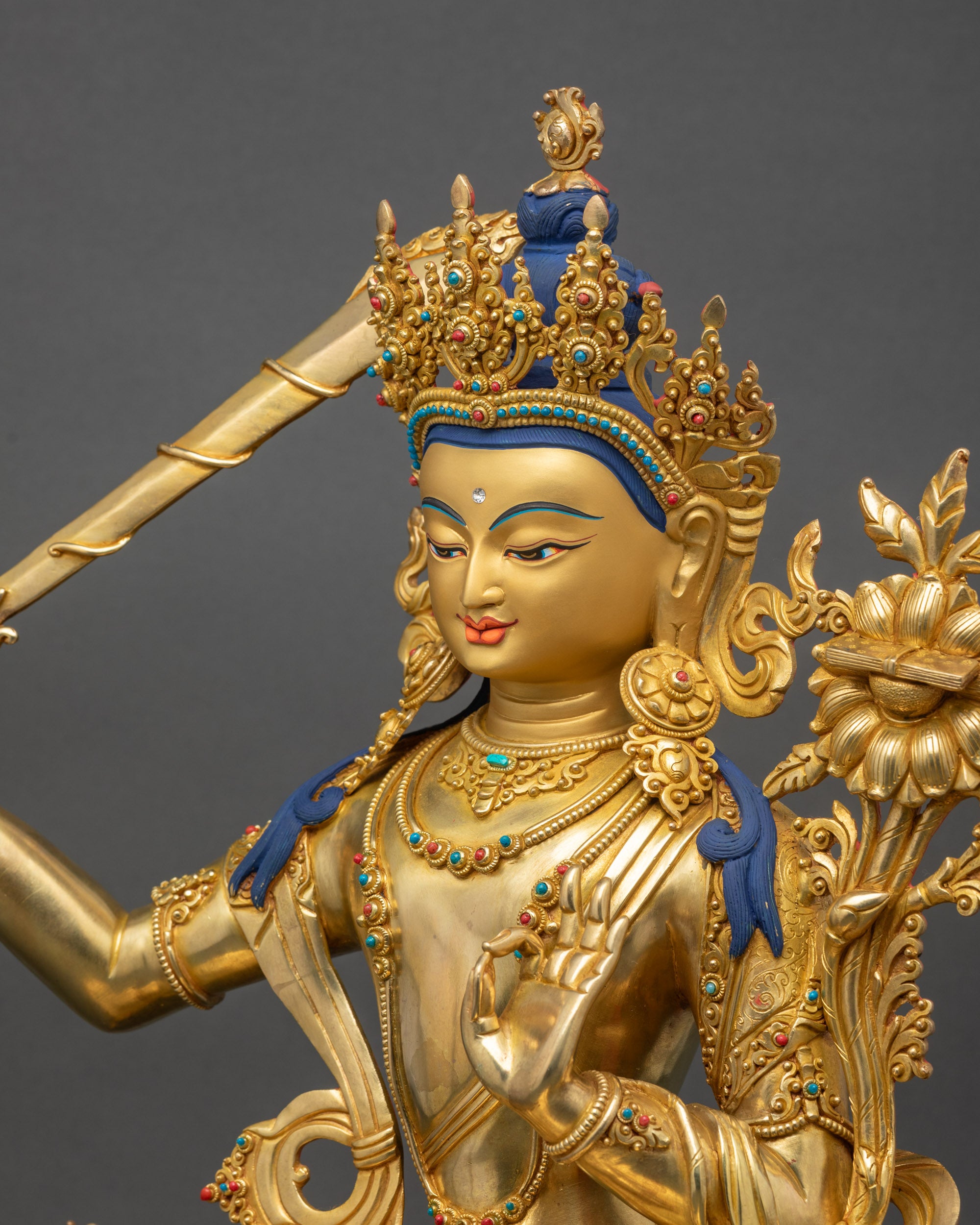 Manjushri Figurine detailed close up face gold fire-gilded copper art
