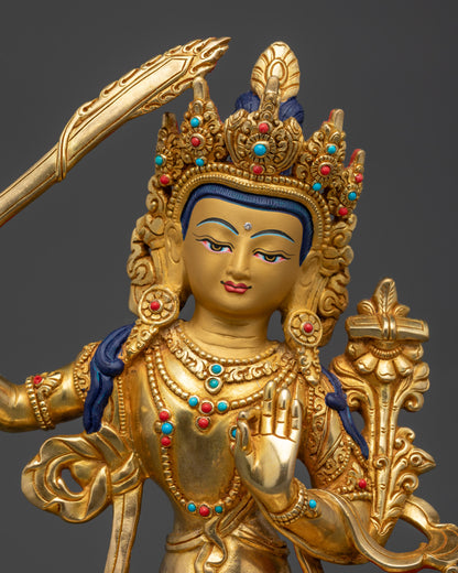 Manjushri Statue close up showing serene gold-gilded face and intricate robes