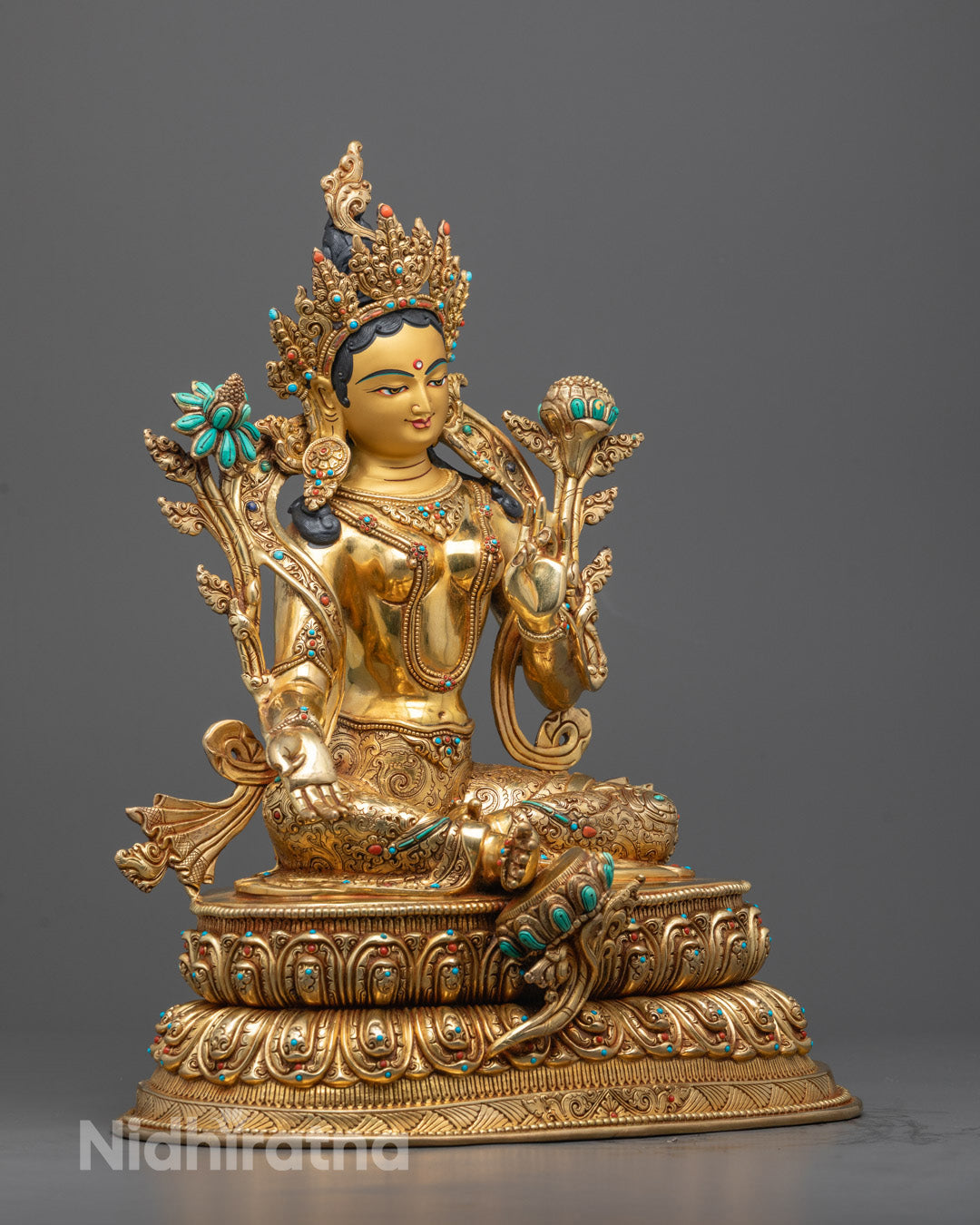 Manjushri deity in meditative posture with raised flaming sword and lotus flower