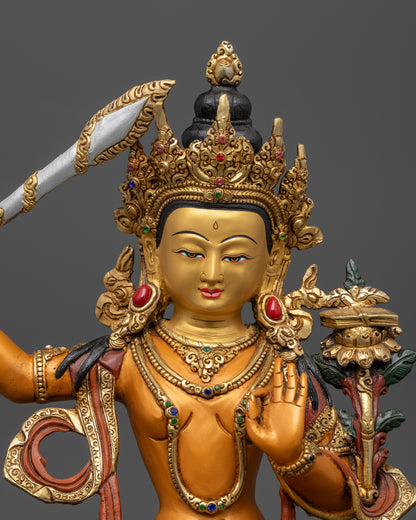 Manjushri’s peaceful golden face, highlighting the intricate detailing and vibrant colors that enhance the statue’s expression of divine wisdom and clarity.