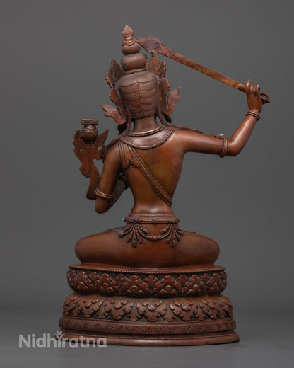 The Manjushri statue, combining traditional Nepalese artistry, elegant oxidized copper finish, and vibrant semi-precious embellishments to inspire clarity and insight.