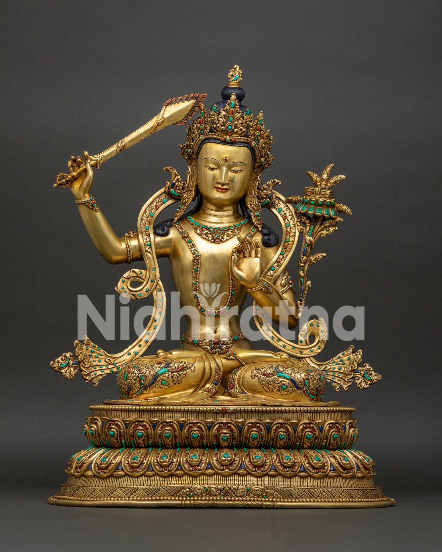Manjushri statue handcrafted in Nepal, gold fire-gilded copper with semi-precious stones, front view