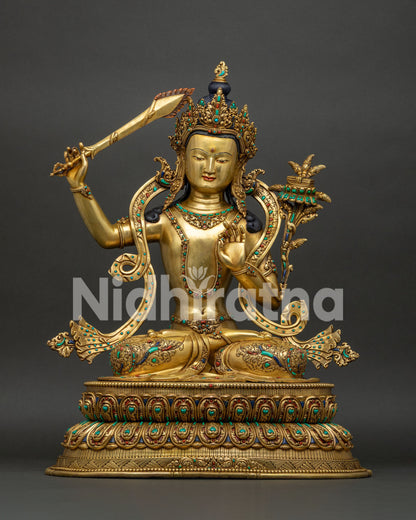Manjushri statue handcrafted in Nepal, gold fire-gilded copper with semi-precious stones, front view