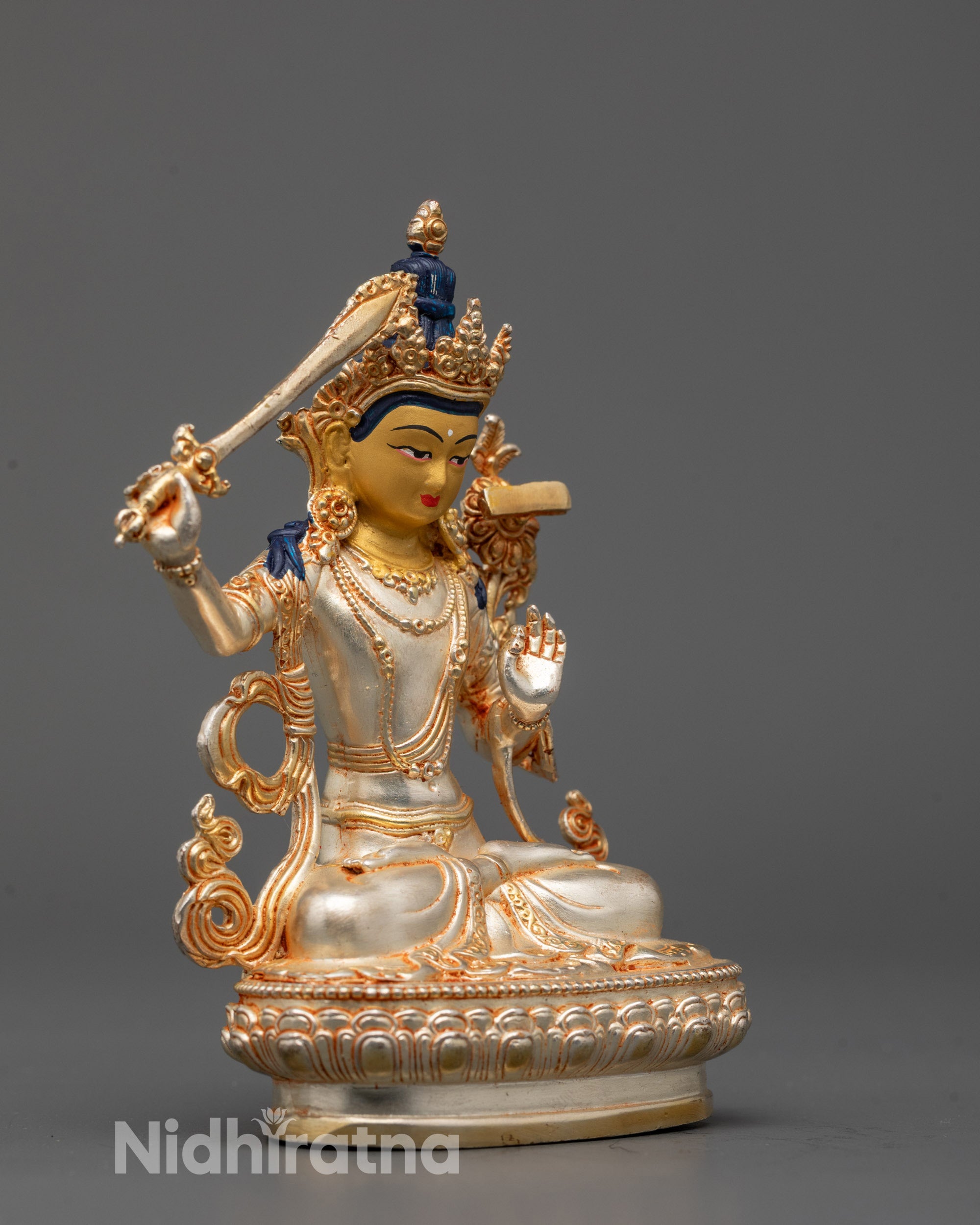 Manjushri statue on silver-plated lotus seat holding sword and utpala flower