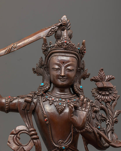 Manjushri statue’s double-edged sword and intricate jewelry showcasing traditional lost wax craftsmanship