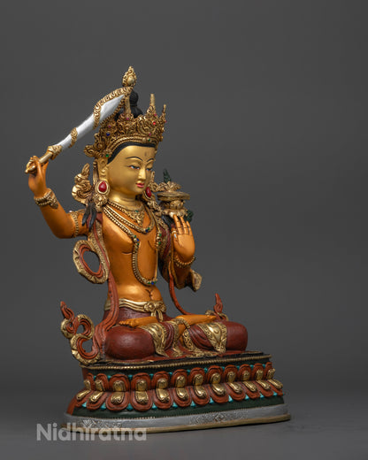 Manjushri statue, showcasing the elegant posture atop a lotus, the radiant gold finish, and the rich acrylic detailing symbolizing enlightenment and purity.