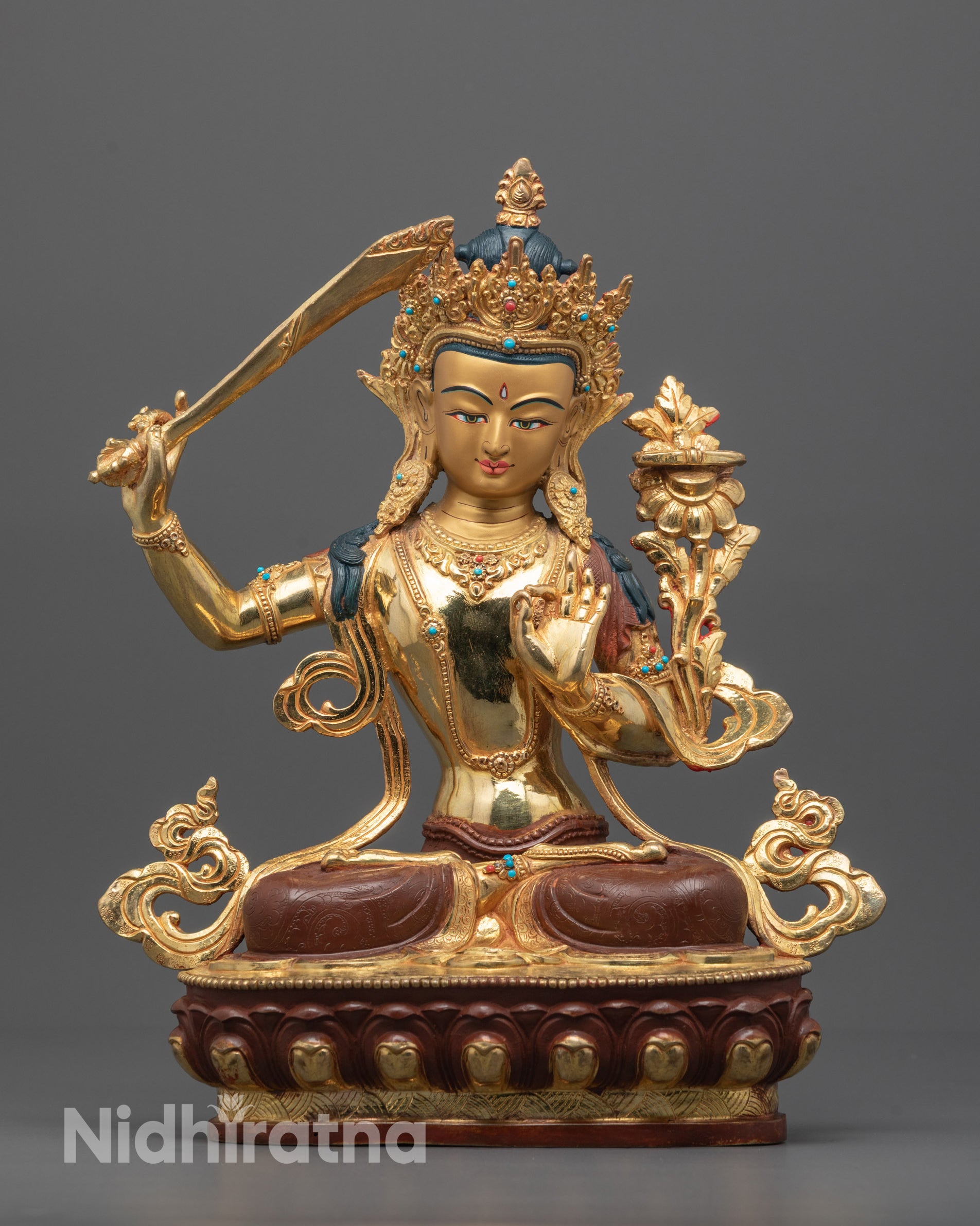 Front view of hand-carved Manjushri Statue seated on a lotus base