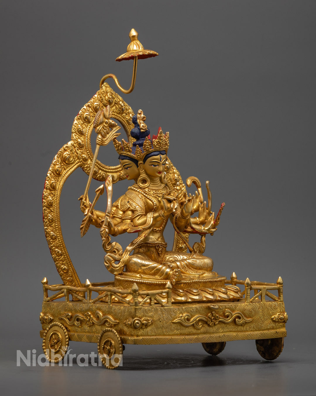 Bodhisattva Marici statue seated on a chariot, showcasing multiple arms and vibrant semi-precious stone inlays
