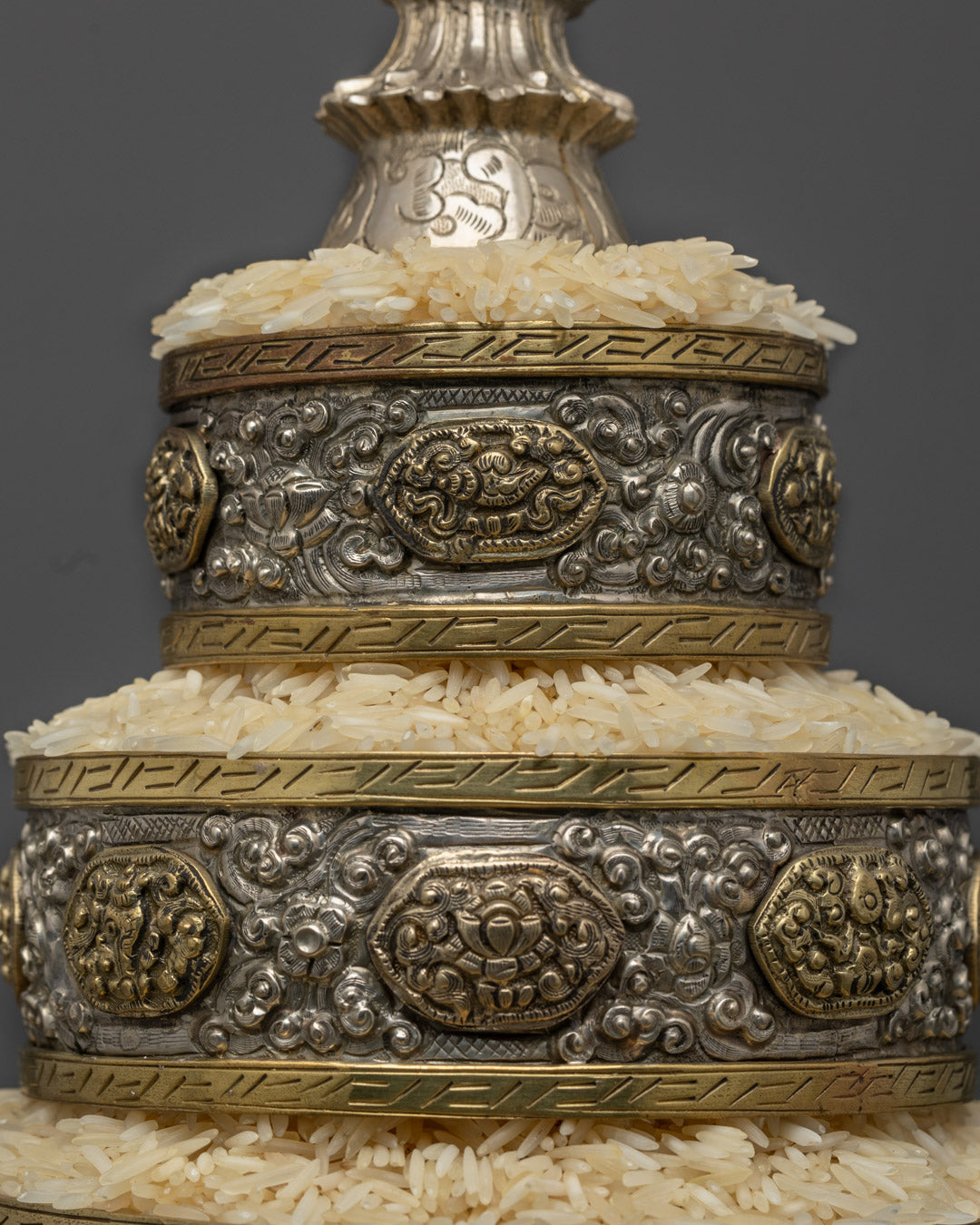 Master artisan handcrafting a silver-plated Ratna Mandala using copper base
