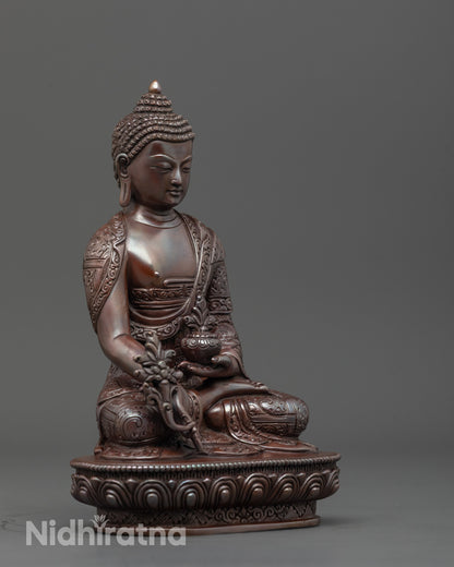 Side angle of Tibetan Medicine Buddha holding monk’s bowl with myrobalan fruit and robe folds