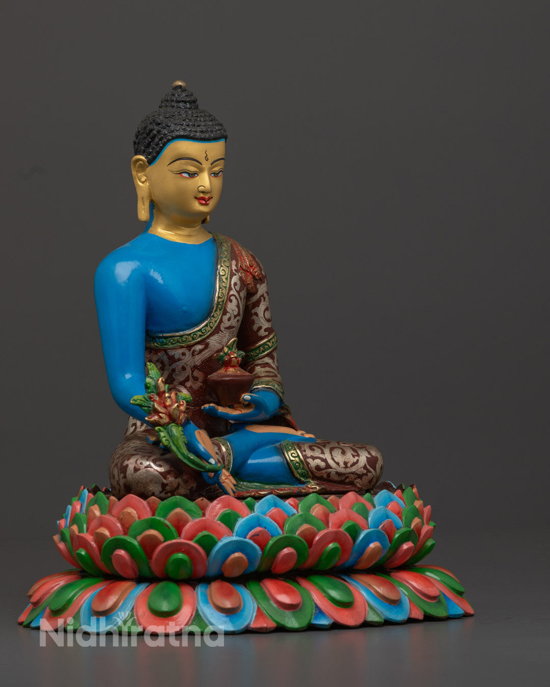 Medicine Buddha Statue showing intricate hand-painted acrylic designs on copper body, crafted in Nepal