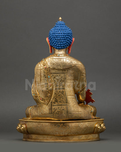 Medicine Buddha statue back view showing detailed carved garments and lotus