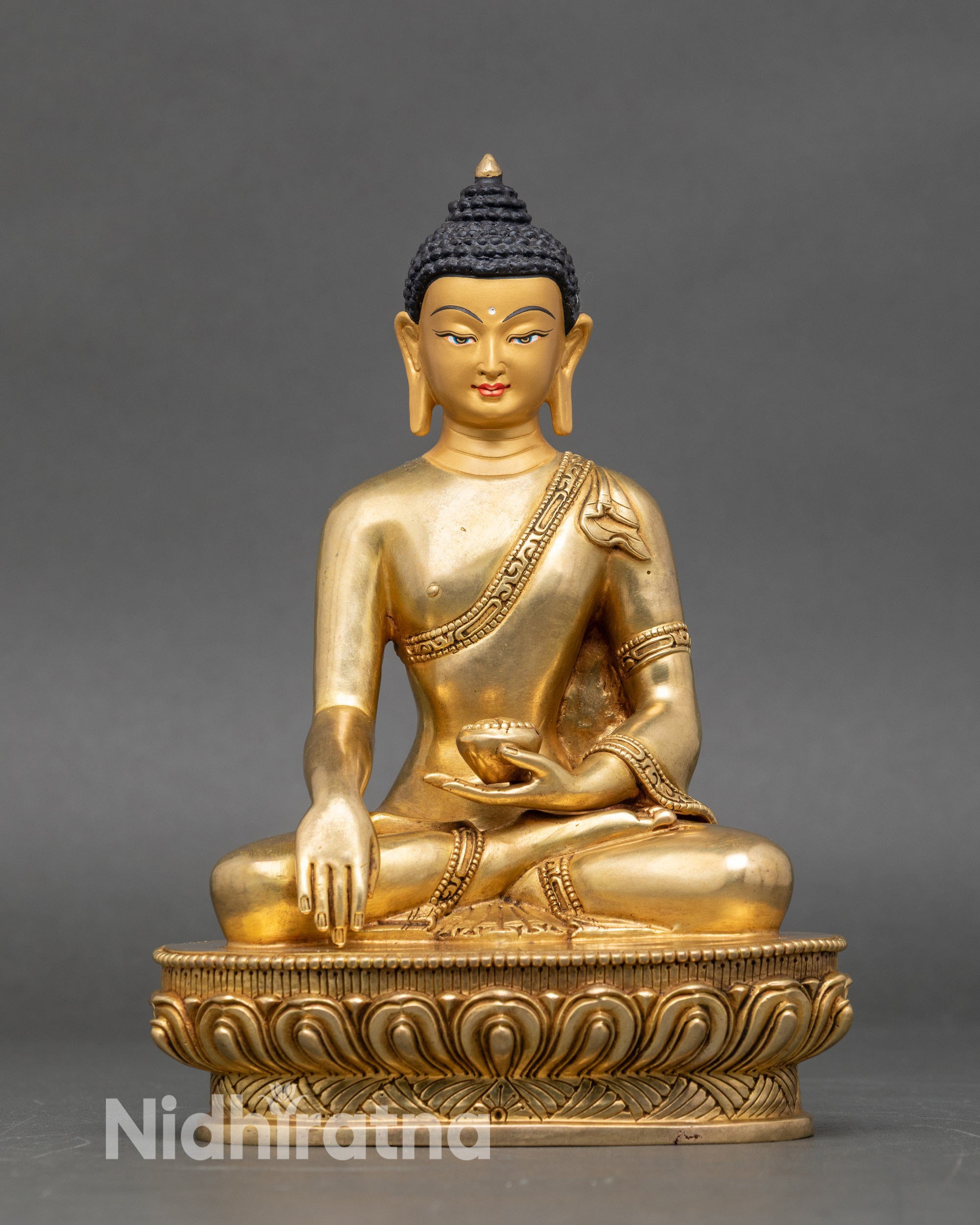 Meditating Shakyamuni Buddha statue front view, handcrafted copper with gold accents
