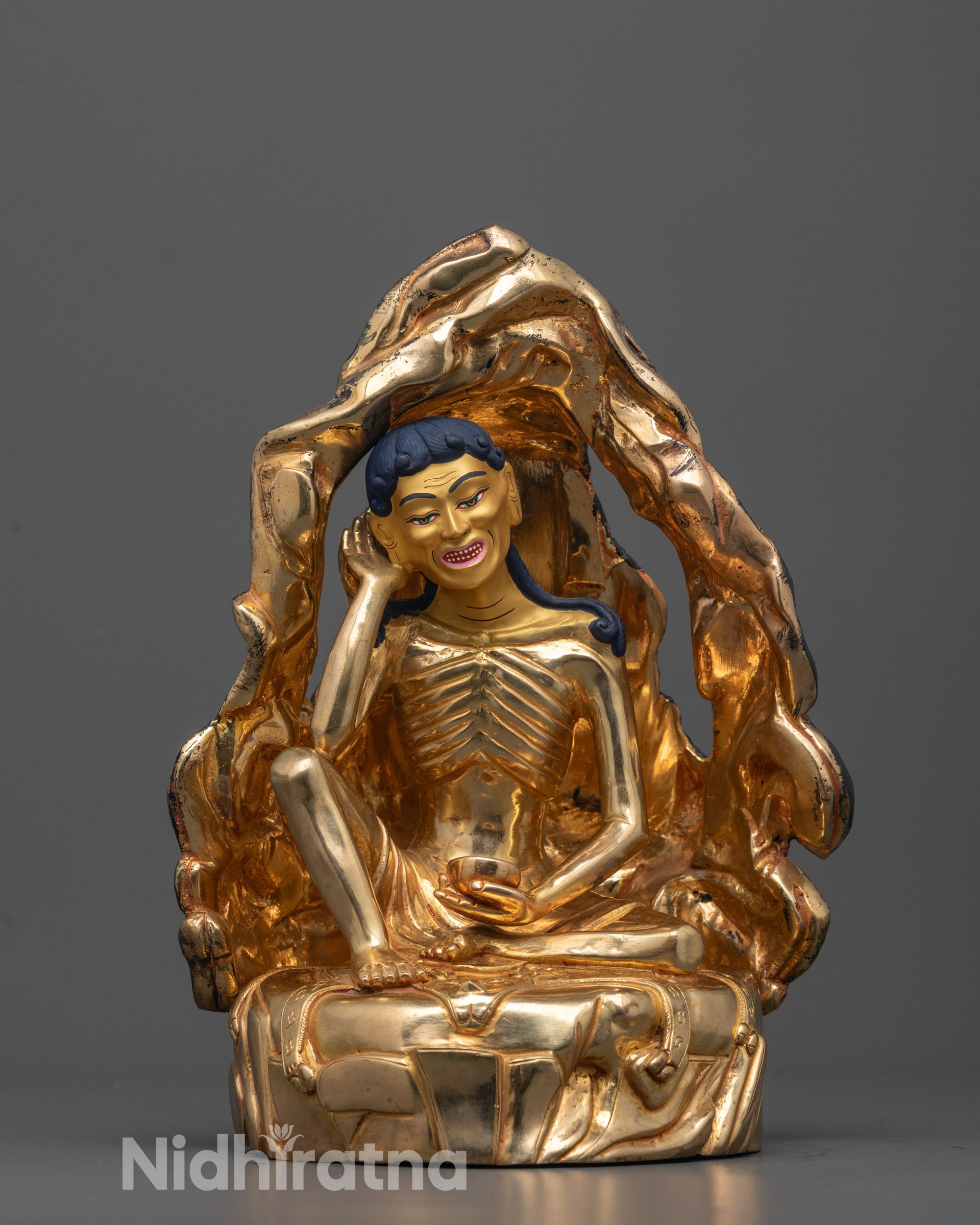 milarepa statue front view with gold-gilded face and copper base