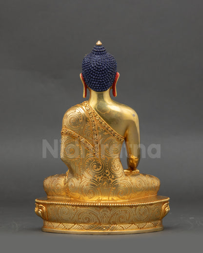Mitrugpa Buddha back view showing carved robe and gold-gilded copper body