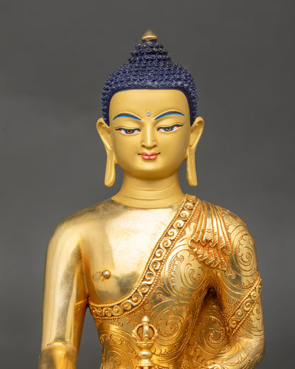 Mitrugpa Buddha statue close up showing gold-gilded body and lotus posture