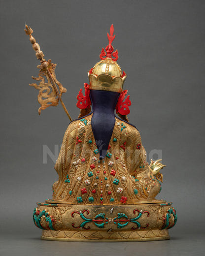 Intricately carved kasaya robe on Guru Padmasambhava statue fire-gilded Nepalese copper