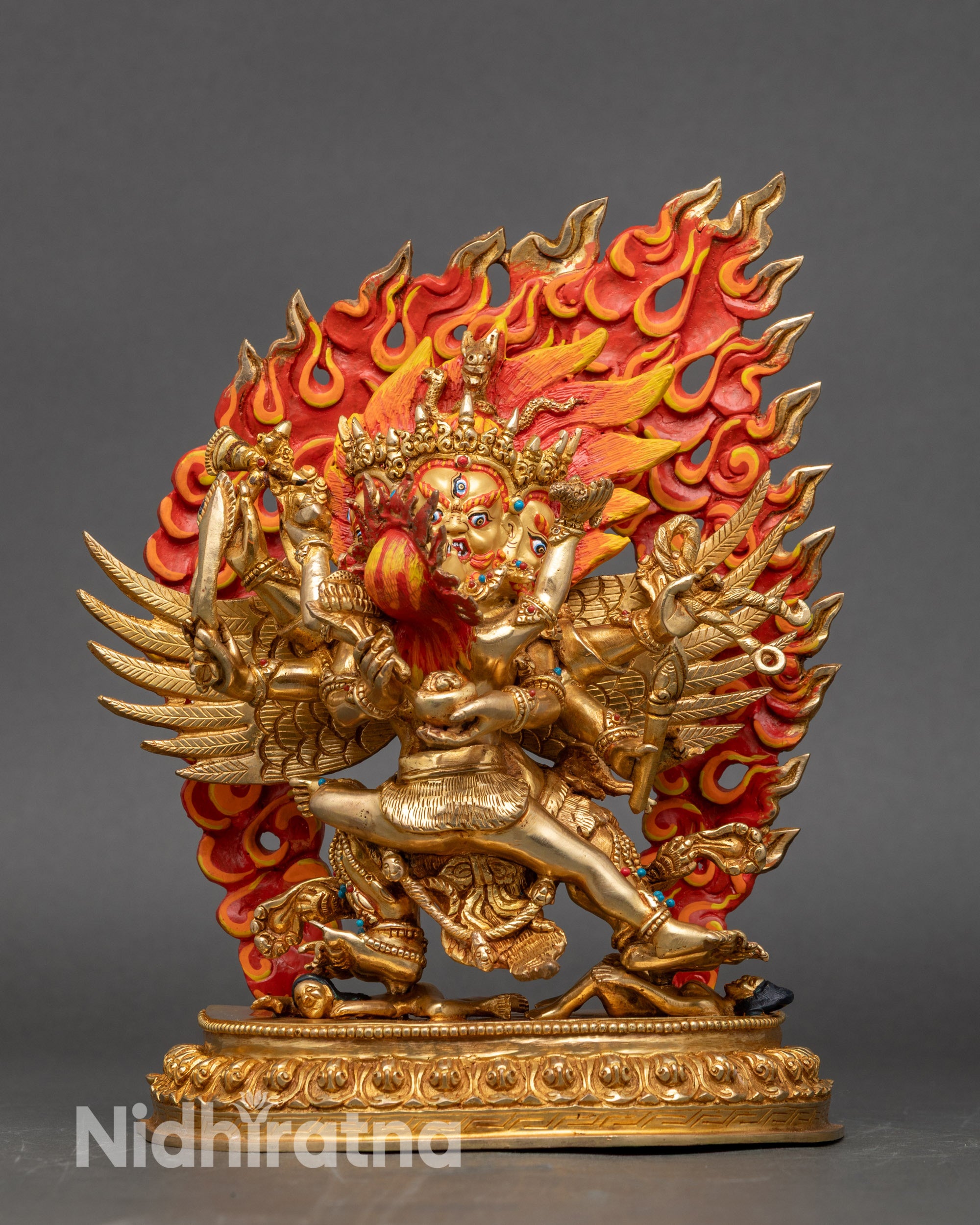 Multi-armed Hayagriva protector statue holding sword, wisdom flame, and lasso