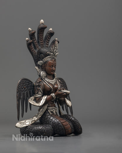 Side-view of Naga Kanya statue seated gracefully, handcrafted by Nepalese master artisans