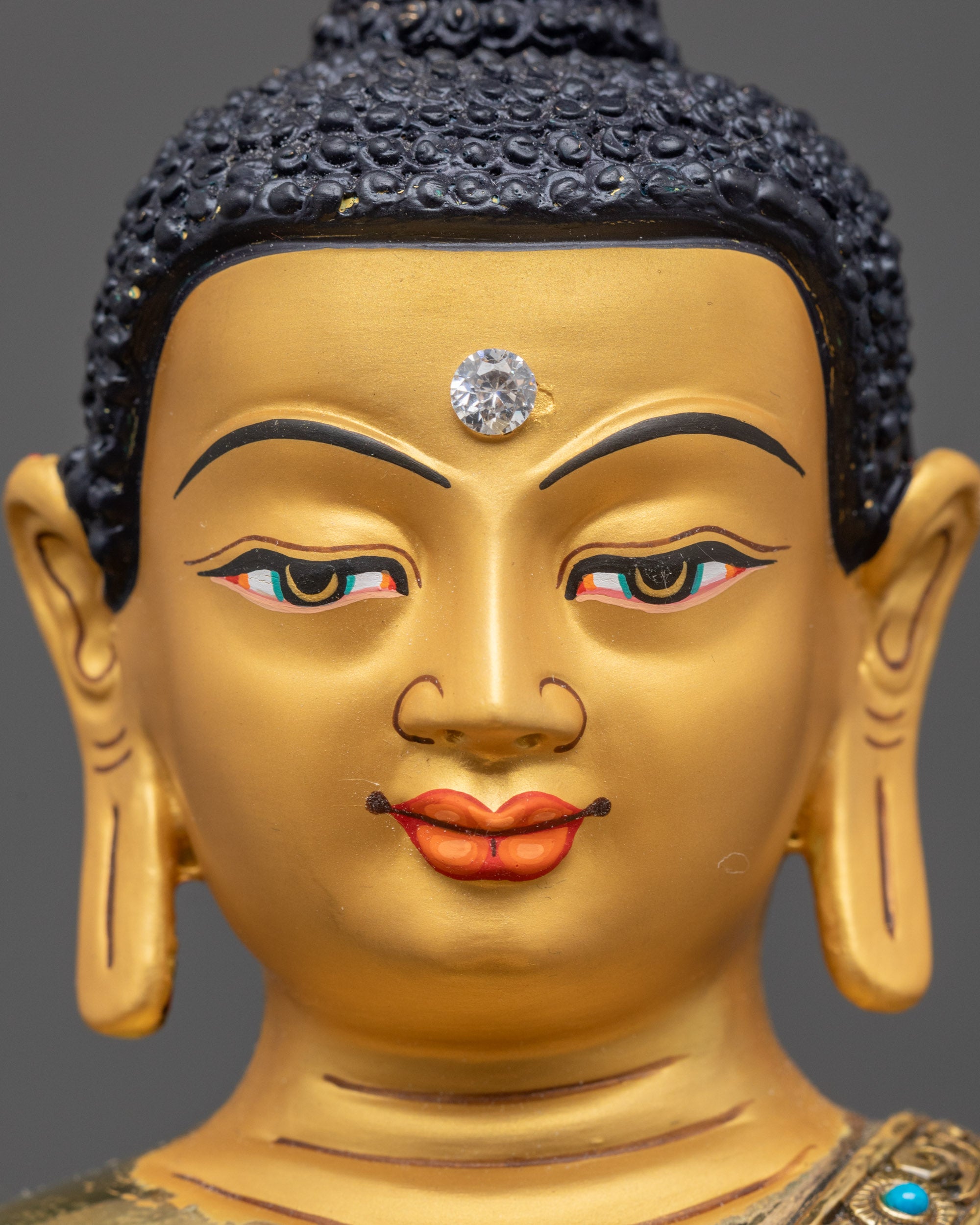 Near view of Shakyamuni Buddha face showing calm expression and intricate carvings
