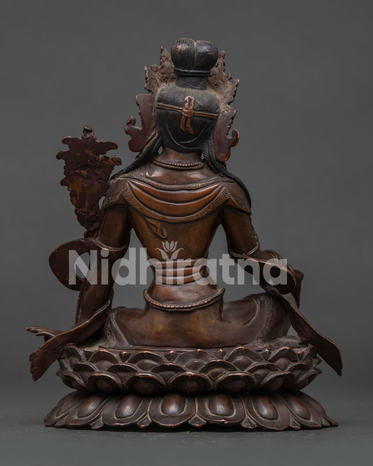 Nepalese Lokeshwor statue with detailed monastic garments and lotus throne.