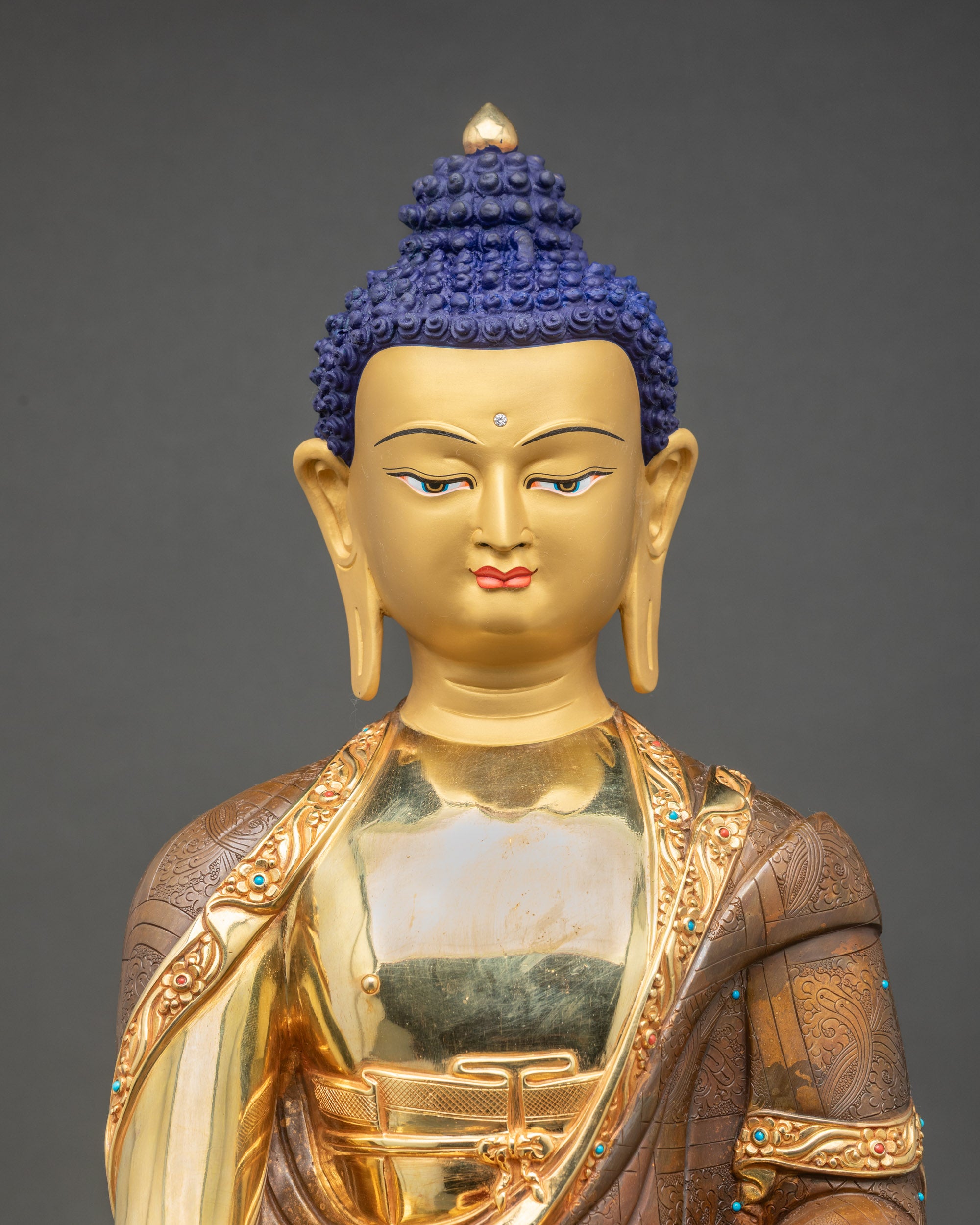 Close-up of Nepalese Buddha Statue showing copper and gold craftsmanship
