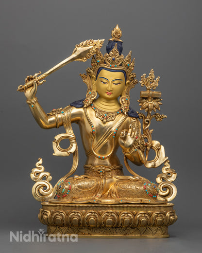 Handcrafted 24k gold gilded Manjushri Buddha Statue sitting on a lotus throne, symbolizing wisdom and enlightenment, with intricate detailing.