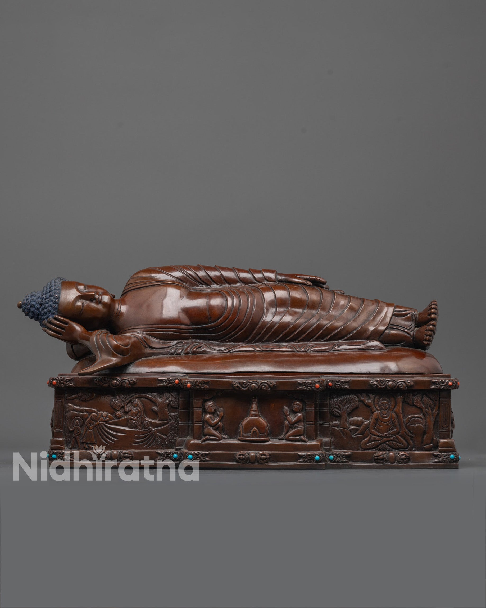 nirvana buddha statue front view showing oxidized copper and parinirvana bed details