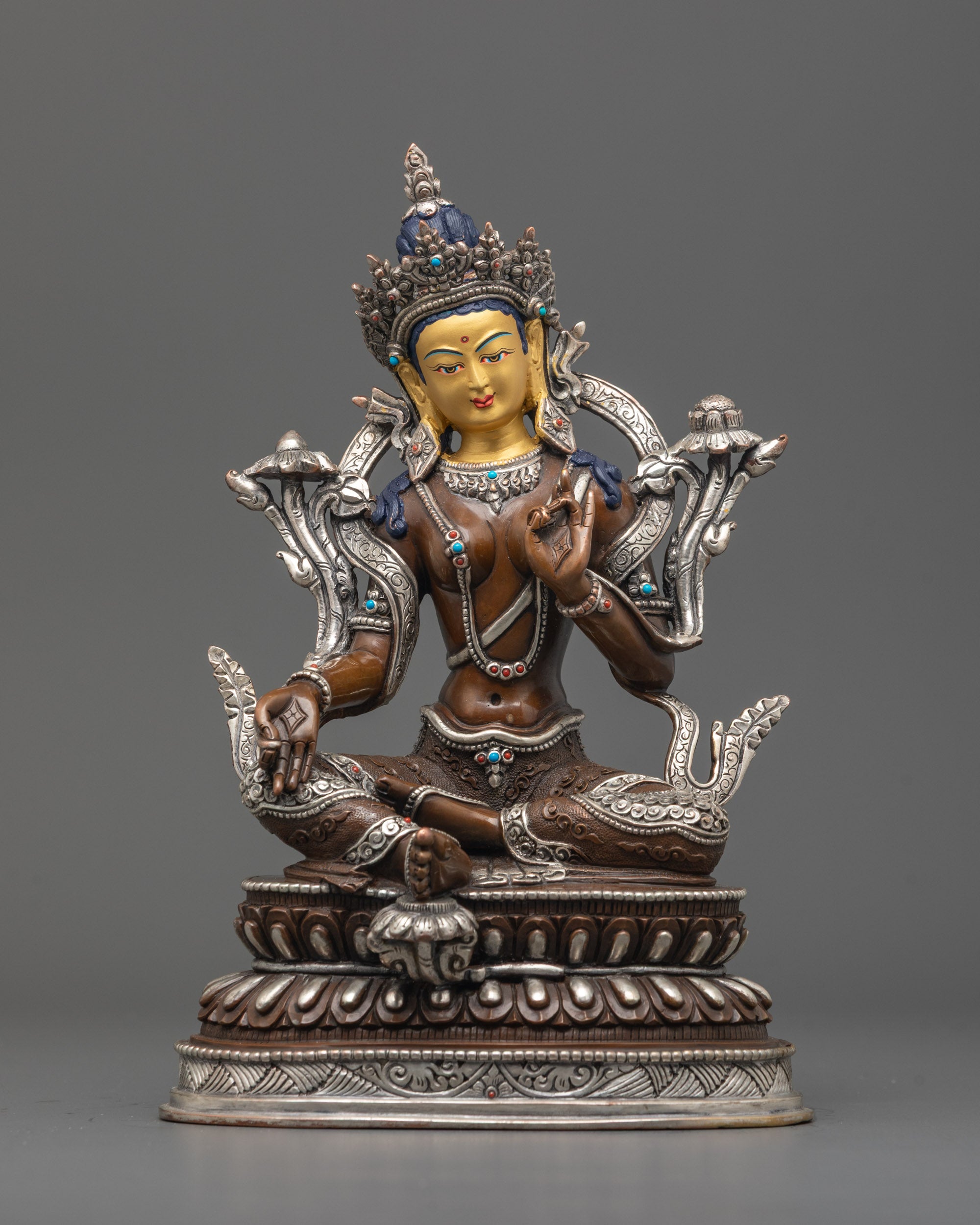 Oxidized Green Tara Statue front view with 24K gold face, silver robe, lotus base.