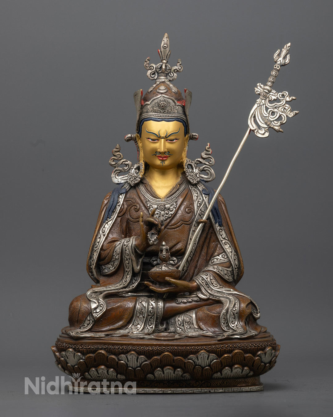 hand-carved Guru Rinpoche Statue with 24K gold-gilded face and silver-plated details, seated on a lotus throne.