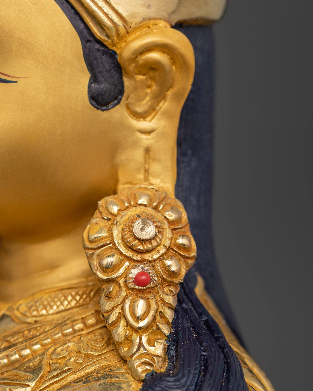 the ear of guru Padmasambhava statue