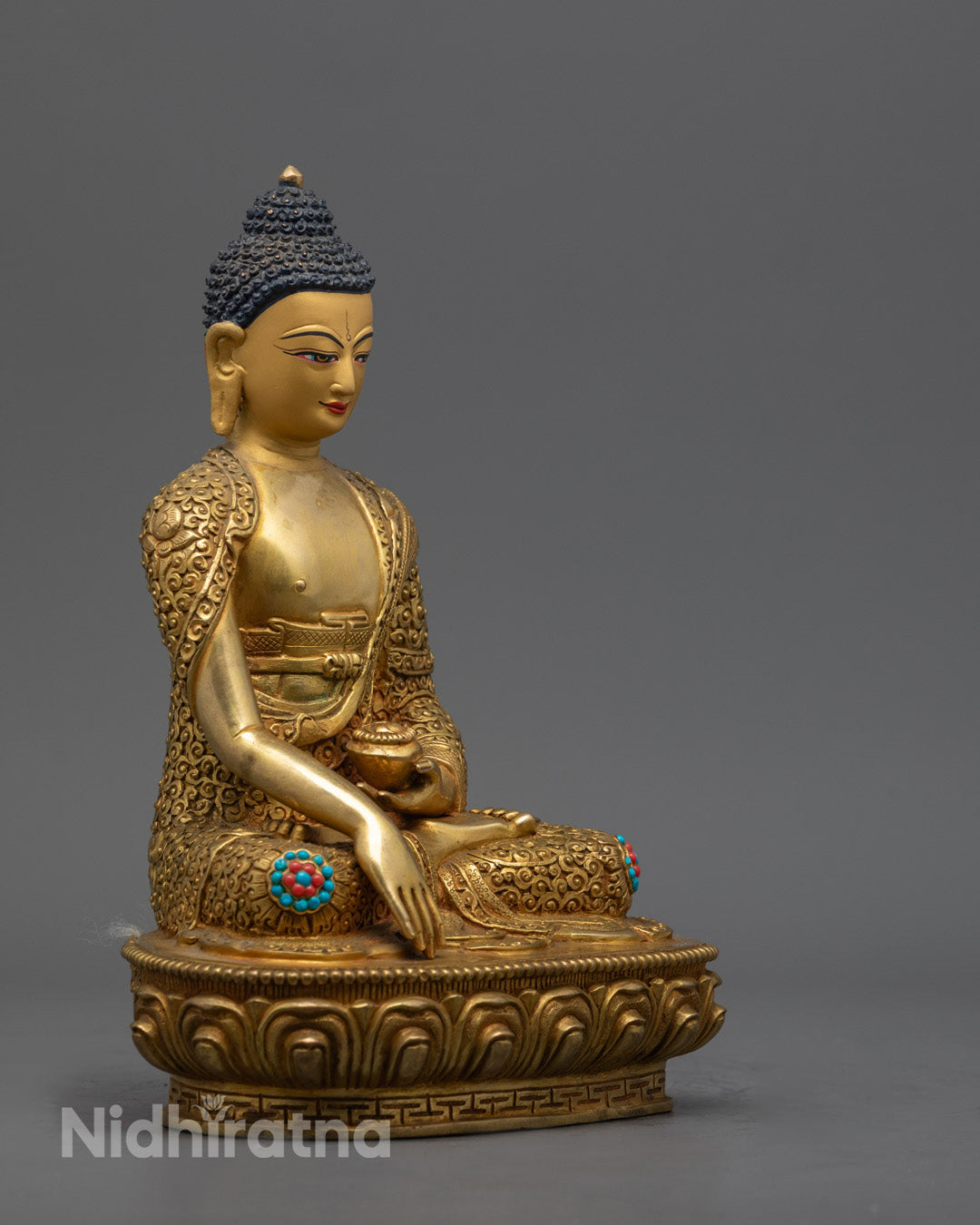 Premium copper Shakyamuni Buddha statue with hollow chamber for auspicious mantra placement, decorated with radiant 24k gold and colorful paint.