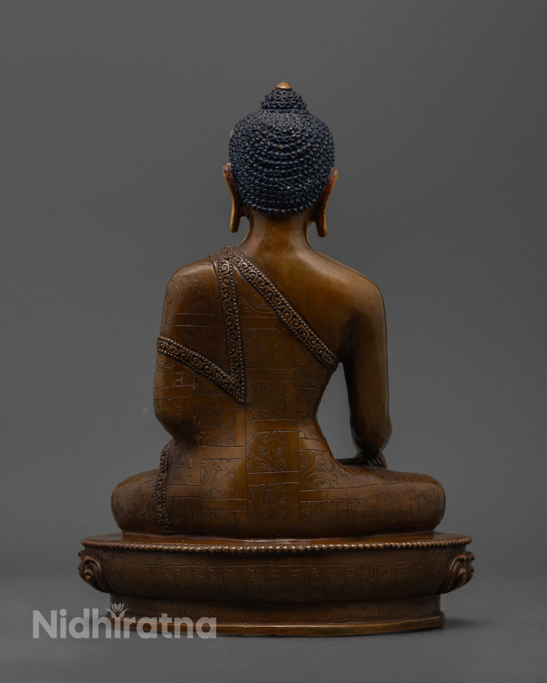 Oxidized copper Shakyamuni statue showcasing intricate patina and lotus throne details