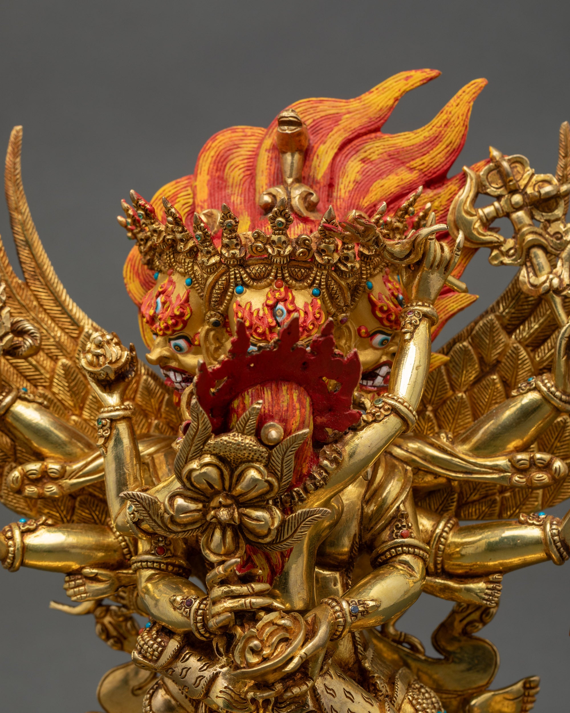 Detailed close-up of Hayagriva’s fierce gold-gilded face, crown, and expressive features.