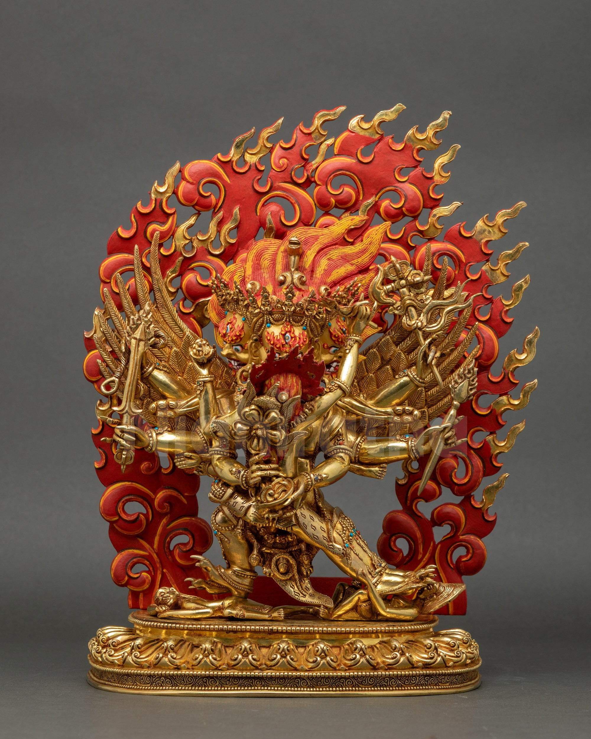 Front view of gold-fire gilded Protector Hayagriva statue, six arms holding sacred object