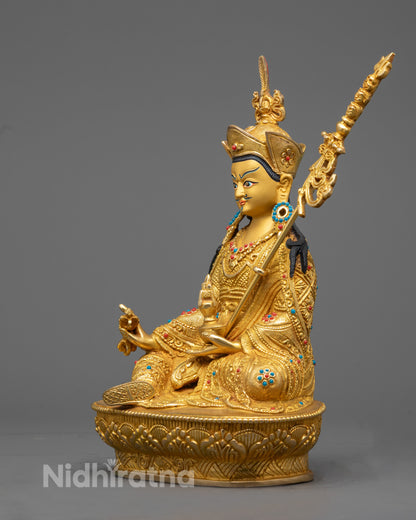 Guru Rinpoche Statue Highlighting Intricate Robe Patterns and Trident Symbol
