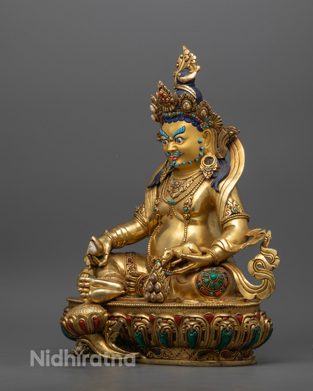 Dzambhala statue showcasing hollow space for mantra fillings and intricate detailing.