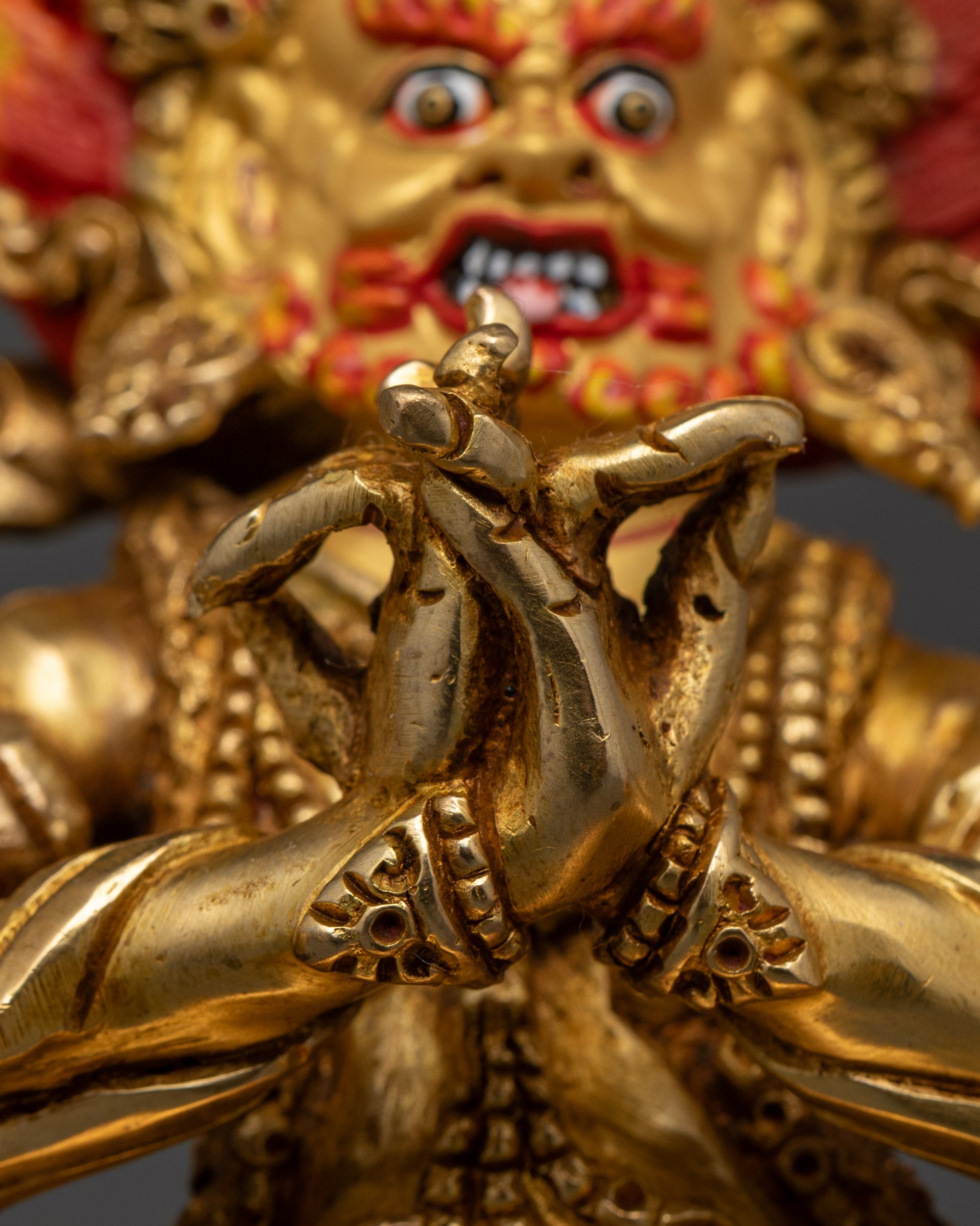Rear view of Four Armed Vajrapani statue featuring intricate gold gilding, lotus base